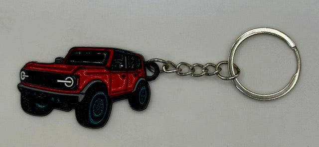 Red SUV keychain on a gray background