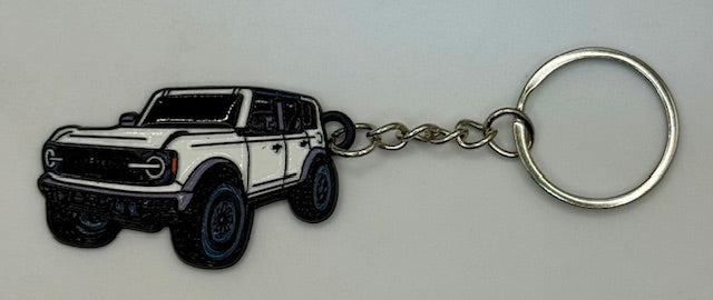 Keychain with a white truck design on a gray background