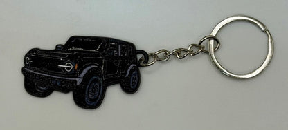 Black truck-shaped keychain on a white background