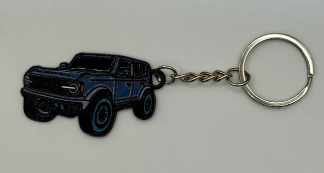 Keychain with carbonized grey SUV design on a light gray background