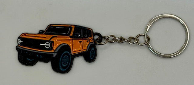 Keychain with cyber orange vehicle design on a gray background