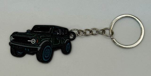 Keychain with green black vehicle design on a gray background